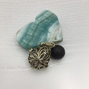 Pattern Egg Shaped Aromatherapy Brass tone Locket.  Lava stone included.